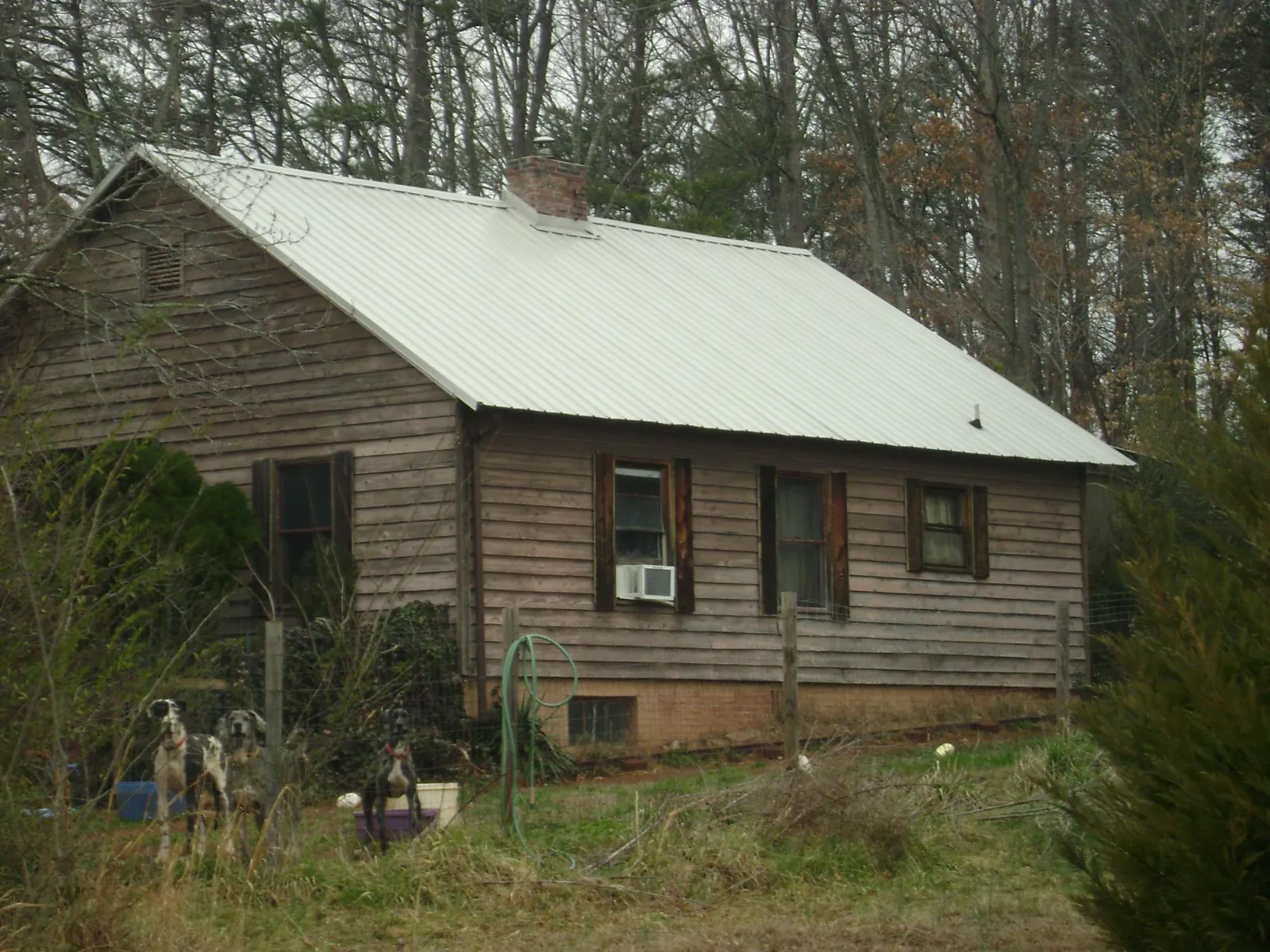 White metal roof on an old wood sided farmhouse, from a Metal Roof Installation job in Amesbury
